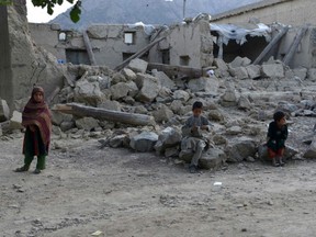 Children sit outside a damaged house after a recent earthquake at Akhtar Jan village in Gayan district of Paktika province, Afghanistan, Saturday, June 25, 2022.Getty Images)