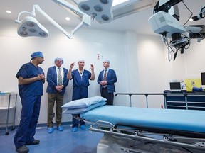 FILE PHOTO: From left; Dr. Amin Kherani, eye surgery patient Stan Grad, Dr. Geoff Williams and Alberta Minister of Health Tyler Shandro tour an operating room at the Southern Alberta Eye Centre following a government announcement on surgery wait times on Tuesday, December 10, 2019.