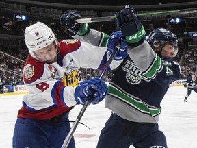 Braeden Wynne of the Edmonton Oil Kings (left) jostles with Conner Roulette of the Seattle Thunderbirds during Game 2 of the Western Hockey League final on June 5, 2022.