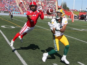 Calgary Stampeders defensive back Dionté Ruffin and Edmonton Elks' receiver Derel Walker clash during CFL action at McMahon Stadium in Calgary on Saturday, June 25, 2022.