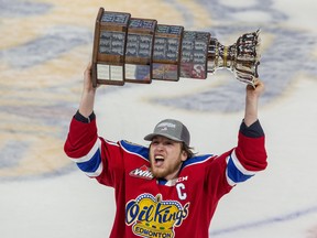 Edmonton Oil Kings captain Jake Neighbours (21) hoists the Ed Chynoweth Cup after defeating the Seattle Thunderbirds 2-0 to win the Western Hockey League Championship series on Monday, June 13, 2022.