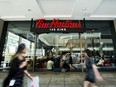 People walk past a newly-renovated Tim Hortons in Toronto, Thursday, July 25, 2019.&ampnbsp;Tim Hortons has joined a growing list of corporations pulling financial support for Hockey Canada in the wake of the federation's handling of an alleged sexual assault.&ampnbsp;THE CANADIAN PRESS/Nathan Denette