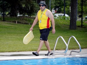 Lifeguard Russell Keewatin keeps a close eye on patrons at Queen Elizabeth Outdoor Pool on Wednesday June 22, 2022.