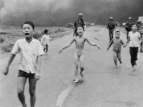 In this June 8, 1972, file photo, 9-year-old Kim Phuc, center, runs with her brothers and cousins, followed by South Vietnamese forces, down Route 1 near Trang Bang after a South Vietnamese plane accidentally dropped its flaming napalm on its own troops and civilians.