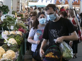 Customers make their way through the stalls for produce at Jean-Talon Market on Saturday June 25, 2022.