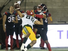 Montreal Alouettes defensive halfback Wesley Sutton (37) gets called for pass on Edmonton Elks slotback Kenny Lawler (89) in Montreal on Thursday, July 14, 2022.