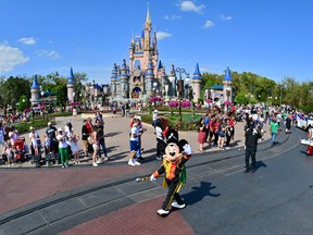 Mickey Mouse waves to fans during a parade at Walt Disney World Resort on March 3, 2022 in Lake Buena Vista, Florida.