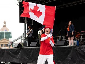 Henry Stephens celebrates his 15th Canada Day by dancing while The Hearts perform during Canada Day celebrations at the Alberta legislature in Edmonton on Friday, July 1, 2022.
