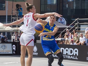 Romania's Violet Stoenescu passes the ball behind Canada's Michelle Plouffe during FIBA 3x3 Women's Series  action on Friday, July 29, 2022  in Edmonton.    Greg Southam-Postmedia