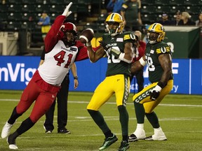 Edmonton Elks' quarterback Kai Locksley (10) is hit by Calgary Stampeders' Mike Rose (41) for a penalty during second half CFL action at Commonwealth Stadium in Edmonton, on Thursday, July 7, 2022.