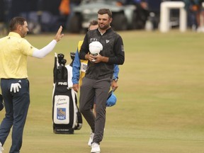 Canadian Corey Conners (right) and Spain's Sergio Garcia finish up their final rounds at the British Open on Sunday.