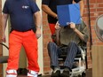 Former Nazi concentration camp guard Josef S. (right) hides his face with a folder as he arrives on June 28, 2022 at a gym used as a makeshift courtroom in Brandenburg an der Havel, Germany, where his verdict was spoken.