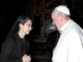 Italian nun Sister Raffaella Petrini, who is the first woman to be appointed as the number two position in the governorship of Vatican City, is greeted by Pope Francis in this undated handout photo released by the Vatican on November 5, 2021.