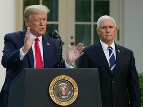In this file photo taken April 27, 2020, then-U.S. President Donald Trump speaks as former U.S. Vice President Mike Pence looks on during a news conference COVID-19 in the Rose Garden of the White House in Washington, D.C.