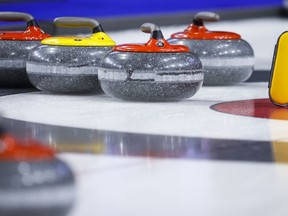 A broom and curling stones are shown at the Brier in Lethbridge, Alta., Sunday, March 6, 2022. The Continental Cup curling tournament has been cancelled for a third straight season as Curling Canada continues to revamp its competition schedule for the 2022-23 campaign.