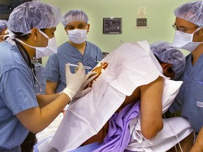 A patient receives an an anaesthetic prior to an epidural at an Ottawa hospital.