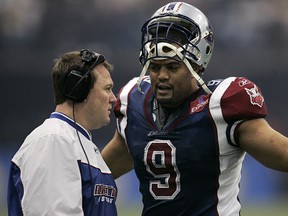 Vancouver--11/27/05--Montreal Alouettes defensive lineman Anwar Stewart consults with defensive coordinator Chris Jones during the second half of the 2005 Grey Cup in Vancouver Sunday.(Sports/Zurkowsky story)GAZETTE PHOTO BY JOHN MAHONEY