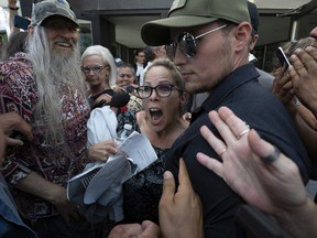 Supporters surround Freedom Convoy organizer Tamara Lich as she leaves the courthouse after being released from jail on Tuesday, July 26, 2022, in Ottawa.