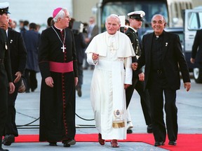 Archbishop Joseph MacNeil, left, accompanies Pope John Paul II and a member of his entourage upon his arrival at Namao Airport in September 1984.