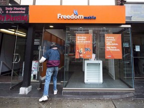 A man enters a Freedom Mobile store in Toronto on November 24, 2016.