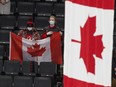 In this Dec. 28, 2021 file photo, Team Canada fans watch as the Canadian flag is raised following the team's win over Team Austria at the IIHF World Junior Hockey Championship in Edmonton.