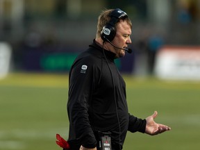Edmonton Elks general manager and head coach Chris Jones speaks on his headset while his team plays the Winnipeg Blue Bombers at Commonwealth Stadium in Edmonton on July 22, 2022.