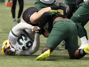 Jaylan Guthrie (63) and Ese Mrabure (92) get into a fight during an Edmonton Elks practice at Commonwealth Stadium in Edmonton on Tuesday, Aug. 2, 2022.