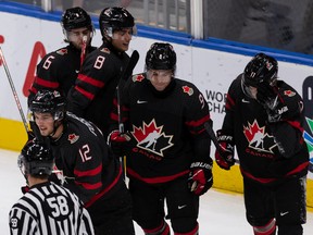 Team Canada's Tyson Foerster (12) celebrates a goal with teammates on Team Finland's goaltender Leevi Merilainen (1) during first period IIHF 2022 World Junior Championship play at Rogers Place in Edmonton, on Monday, Aug. 15, 2022. Photo by Ian Kucerak