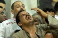 Egyptian mourners react during the funeral of victims killed in Cairo Coptic church fire, at the church of the Blessed Virgin Mary in the Giza Governorate on Aug. 14, 2022.