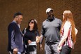 From left, former NFL player Ken Jenkins and his wife Amy Lewis, along with former NFL player Clarence Vaughn III and his wife Brooke Vaughn, meet before delivering tens of thousands of petitions demanding equal treatment for everyone involved in the settlement of concussion claims against the NFL, to the federal courthouse in Philadelphia, Friday, May 14, 2021.