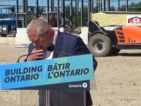 Ontario Premier Doug Ford reacts after a bee flew into his mouth during a press conference in Dundalk, Ont., on Friday, Aug. 12, 2022, in this image taken from video.