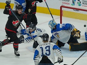 Team Canada's Joshua Roy (9) scores on Team Finland goalkeeper Juha Jatkola during first period gold medal final game action at  the International Ice Hockey Federation 2022 World Junior Championship in Edmonton, Canada on Saturday August 20, 2022.