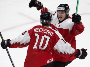 Team Austria's Lukas Necesany (10) and Senna Peeters (17) celebrate a second period goal against Team Canada during IIHF World Junior Hockey Championship action in Edmonton on Dec. 28, 2021.