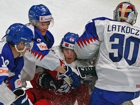 Team Czechia forward Juri Kulich is checked into Team Slovakia goalkeeper Simon Latkoczy by defenceman Denis Bakala during the opening game of the International Ice Hockey Federation 2022 World Junior Championship, on Tuesday, Aug. 9, 2022, at Rogers Place in Edmonton.