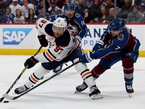 Connor McDavid of the Edmonton Oilers fights for the puck against Devon Toews of the Colorado Avalanche during the first period in Game Two of the Western Conference Final of the 2022 Stanley Cup Playoffs at Ball Arena on June 02, 2022, in Denver, Colo.