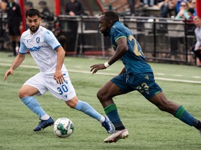 FC Edmonton's Gabriel Bitar (30) chases York United FC's Chrisnovic N'Sa (23) during first half Canadian Premier League action at Clarke Stadium in Edmonton, on Friday, July 1, 2022.