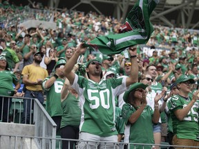 A Saskatchewan Roughriders fan cheers during the Labour Day Classic against the Winnipeg Blue Bombers at Mosaic Stadium on Sept. 4, 2022, in Regina.