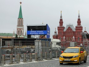 A view shows banners and construction ahead of an expected event dedicated to the results of referendums on the joining of four Ukrainian self-proclaimed regions to Russia, near the Kremlin Wall and the State Historical Museum in Red Square in central Moscow on Sept. 28, 2022. Banners read: "Donetsk, Luhansk, Zaporizhzhia, Kherson. Together forever!"