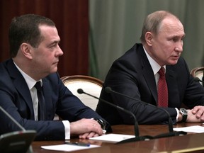 Russian President Vladimir Putin and Prime Minister Dmitry Medvedev attend a meeting with members of the government in Moscow, Jan. 15, 2020.