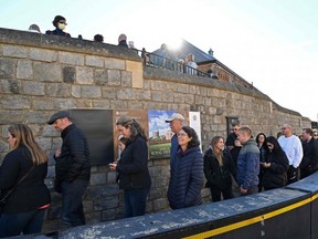 Members of the public and tourists queue to visit Windsor Castle in Windsor, west of London, Thursday, Sept. 29, 2022, as the Castle re-opened to visitors following the death of Queen Elizabeth II.