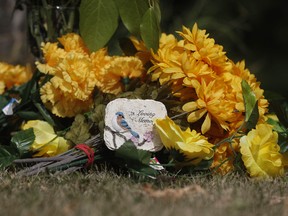 Flowers surround a stone reading "In Loving Memory" in Weldon, Sask., on Wednesday, Sept. 7, 2022.