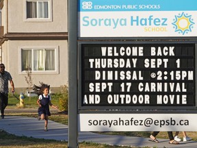 Assil Ebrahmi, 6, and her father Aymen Ebrahmi arrive at Soraya Hafez School in Edmonton for Edmonton Public School's first day of school on Thursday, Sept. 1, 2022.