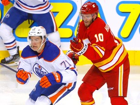 Calgary Flames Jonathan Huberdeau battles Edmonton Oilers Ryan Mcleod in second period NHL preseason action at the Scotiabank Saddledome in Calgary on Sept. 28, 2022.