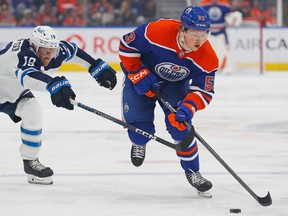 Sep 25, 2022; Edmonton, Alberta, CAN; Winnipeg Jets forward David Gustafsson (19) plays for the puck against Edmonton Oilers forward Reid Schaefer (53)  during the first period at Rogers Place. Mandatory Credit: Perry Nelson-USA TODAY Sports