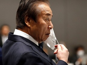 Tokyo Organising Committee of the Olympic and Paralympic Games (Tokyo 2020) then-board member Haruyuki Takahashi puts on a protective face mask following an outbreak of the coronavirus disease (COVID-19), during Tokyo 2020 Executive Board Meeting in Tokyo, Japan March 30, 2020.