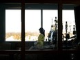 A registered nurse takes a moment to look outside while attending to a ventilated COVID-19 patient in the intensive care unit at the Humber River Hospital during the COVID-19 pandemic in Toronto on Jan. 25, 2022.