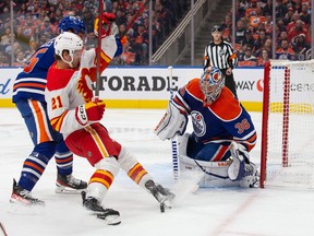 Goaltender Jack Campbell of the Edmonton Oilers defends against Kevin Rooney (No. 21) of the Calgary Flames during the first period at Rogers Place on Saturday, Oct.  15, 2022.