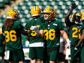 Adam Konar (38) greets Aaron Grymes (36) during the first day of Edmonton Elks training camp at Commonwealth Stadium in Edmonton on May 15, 2022.
