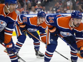 The Edmonton Oilers' Darnell Nurse (25), Dylan Holloway (55), and Devin Shore (14) lineup against the Vancouver Canucks during second period NHL action at Rogers Place in Edmonton, Wednesday Oct. 12, 2022.