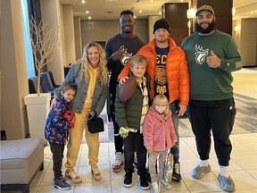 Edmonton Elks J-Min Pelley, right, and Matthew Thomas got to meet Canadian singer Michael Buble and his family during the team's last road trip to Winnipeg.